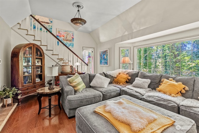 living room with hardwood / wood-style flooring and vaulted ceiling