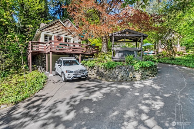 view of front of property with a hot tub and a deck