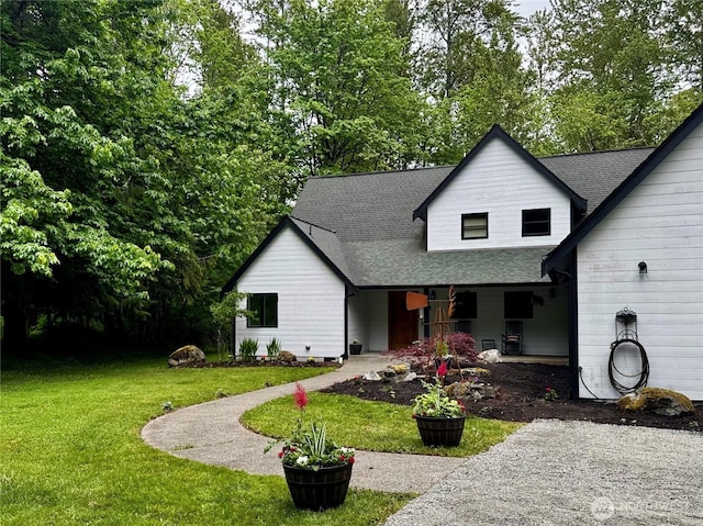 23415 152nd Ave E, Graham, WA 98338 - view of front of home with a shingled roof, a front yard, and covered porch