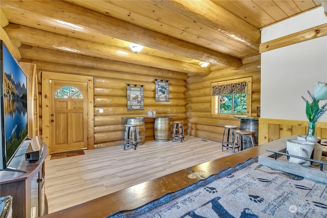 foyer featuring beam ceiling, rustic walls, light hardwood / wood-style flooring, and wooden ceiling