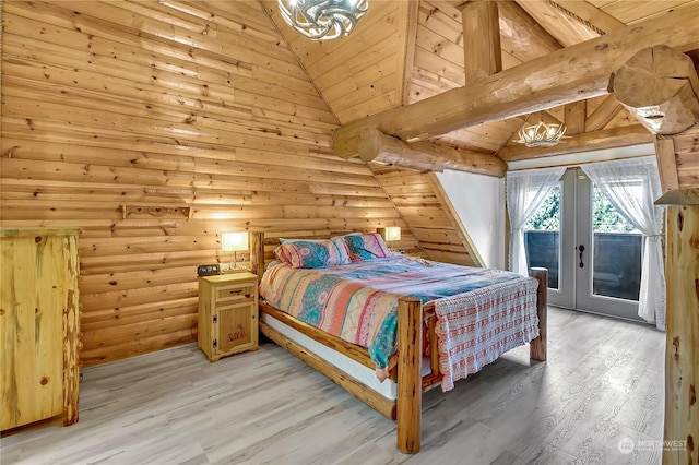 bedroom featuring log walls, access to outside, french doors, beamed ceiling, and light wood-type flooring