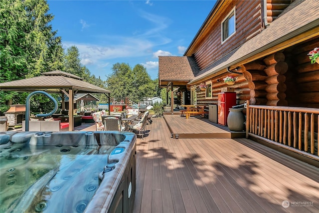 wooden terrace featuring a gazebo and an outdoor hot tub