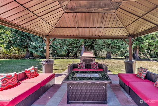 view of patio / terrace featuring a gazebo and an outdoor living space with a fireplace