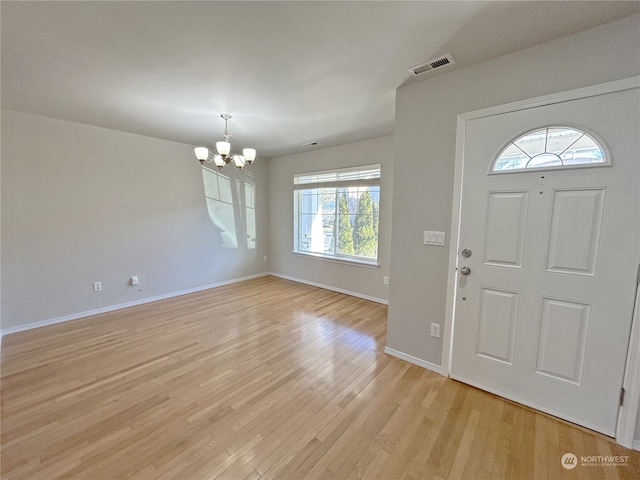 foyer featuring light hardwood / wood-style flooring and a notable chandelier