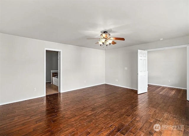 spare room with ceiling fan and dark hardwood / wood-style flooring