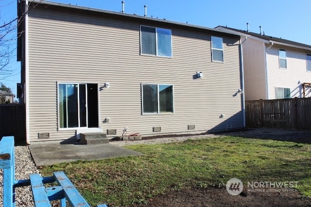 rear view of house with a lawn and a patio area