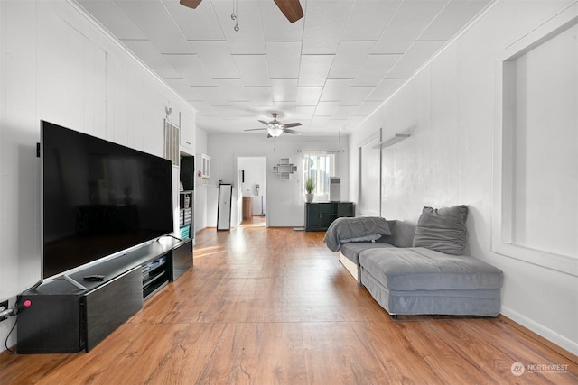 living room featuring light hardwood / wood-style flooring and ceiling fan