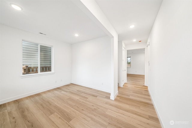 unfurnished room with light wood-type flooring