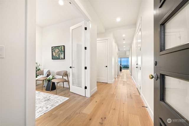 hall with light hardwood / wood-style floors