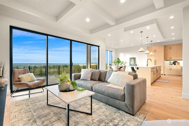 living room with coffered ceiling, sink, beamed ceiling, and light wood-type flooring