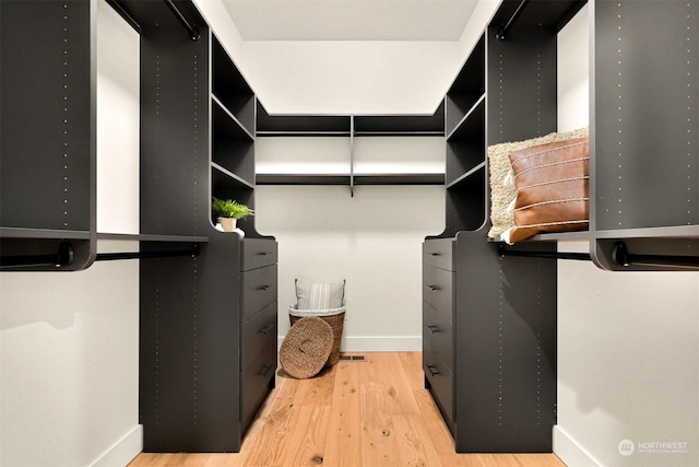 spacious closet with light hardwood / wood-style flooring