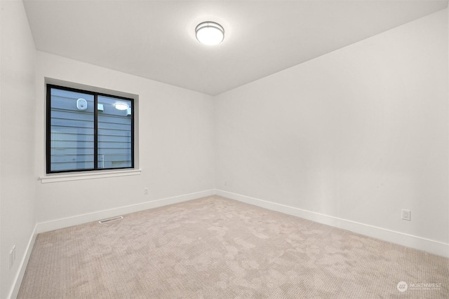 spare room with light colored carpet