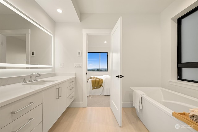 bathroom with vanity and a bathtub