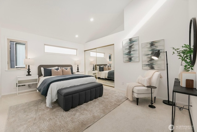 bedroom featuring a closet, carpet flooring, vaulted ceiling, and baseboards