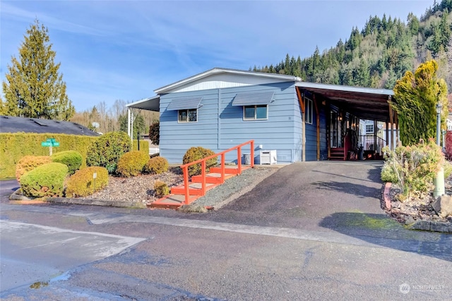 view of side of property featuring a carport