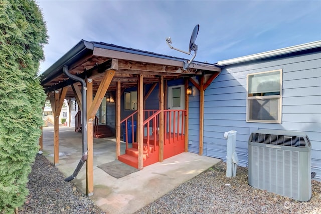 doorway to property with central AC unit