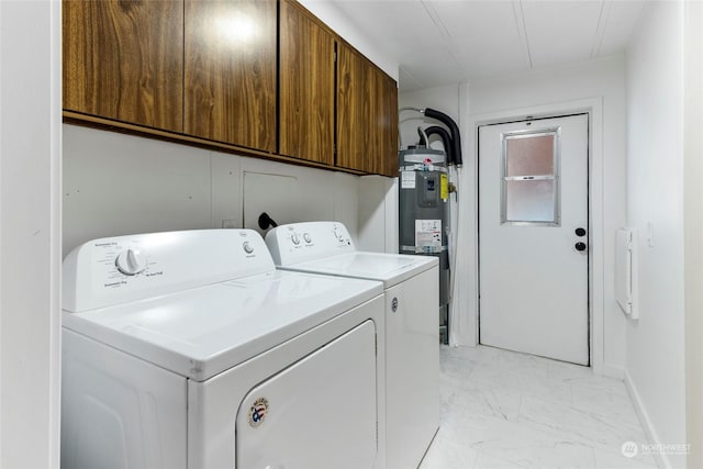 washroom featuring cabinets, separate washer and dryer, and secured water heater