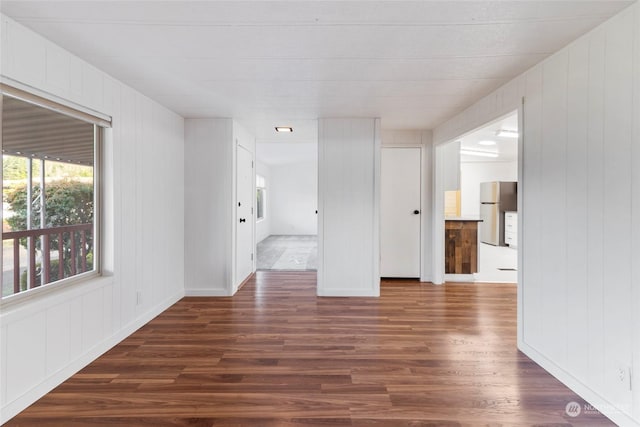 unfurnished room with dark wood-type flooring