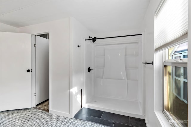 bathroom with tile patterned flooring and a shower