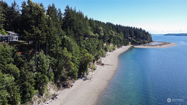 birds eye view of property with a beach view and a water view