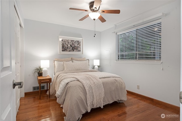 bedroom featuring hardwood / wood-style flooring, a closet, and ceiling fan