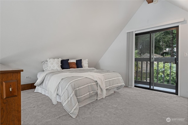 bedroom with access to outside, light colored carpet, and vaulted ceiling