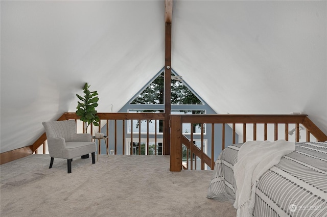 living area with carpet floors and vaulted ceiling with beams