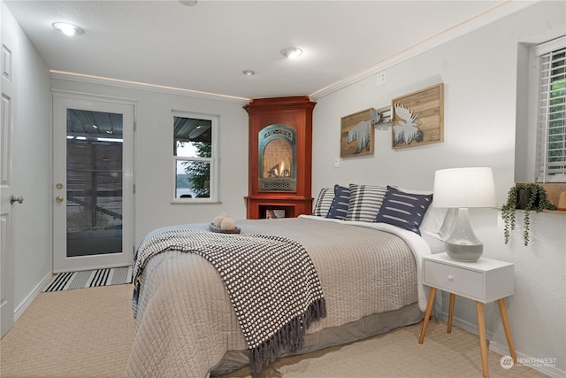 bedroom featuring ornamental molding and carpet