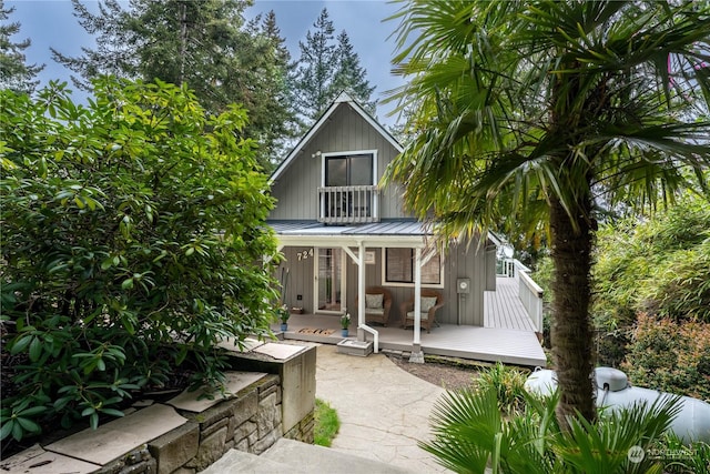 rear view of house featuring a porch