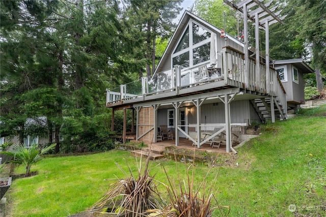 back of house with a wooden deck and a lawn