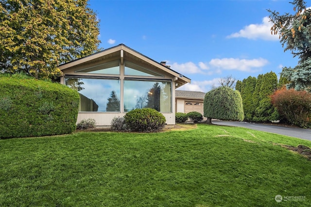 view of home's exterior with a yard and a garage