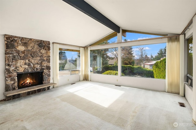 unfurnished sunroom featuring a fireplace and lofted ceiling with beams