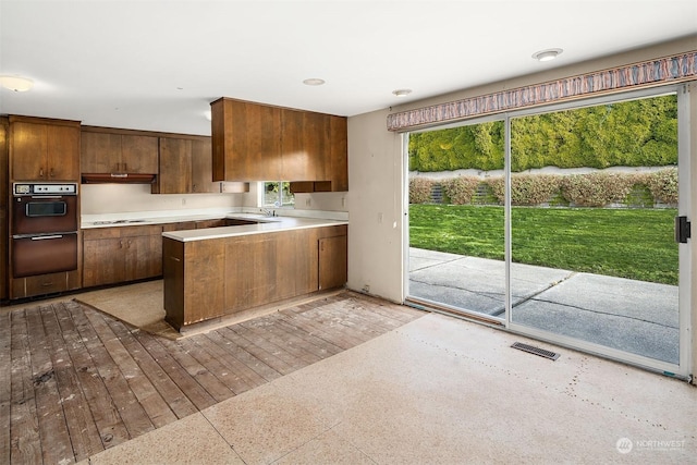 kitchen with wall oven, gas stovetop, and sink