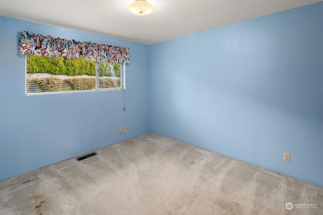 unfurnished room featuring carpet