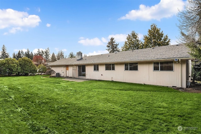 back of house with a yard, a patio, and central air condition unit