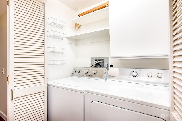 clothes washing area with washer and dryer