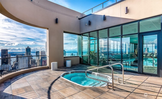 view of swimming pool with a hot tub