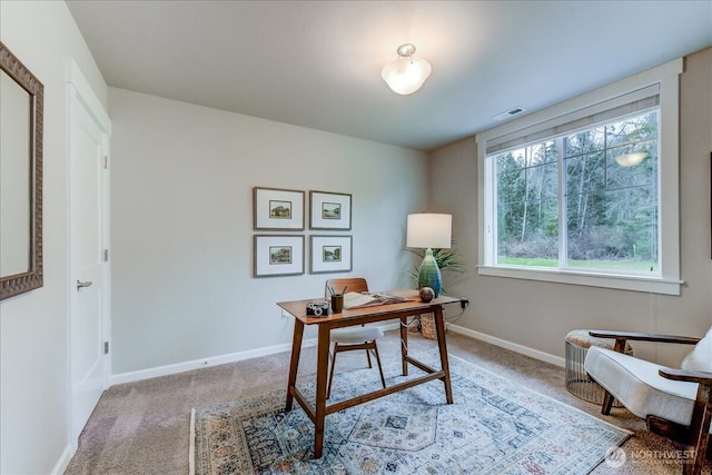 carpeted office space featuring visible vents and baseboards