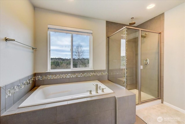 bathroom with a bath and a shower stall