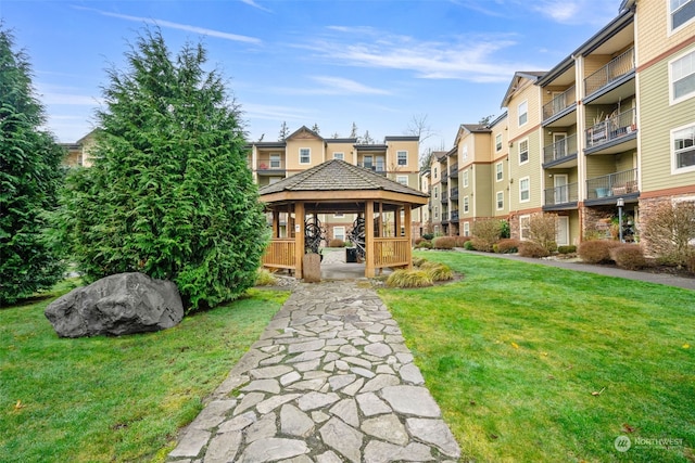 view of property's community featuring a yard and a gazebo