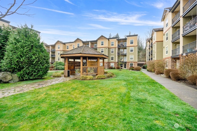 view of property's community with a gazebo and a yard