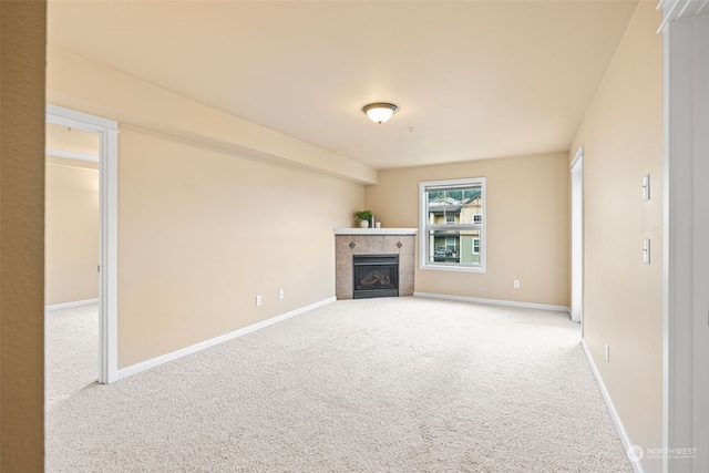 unfurnished living room with carpet floors and a fireplace