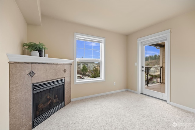 carpeted living room featuring a tiled fireplace