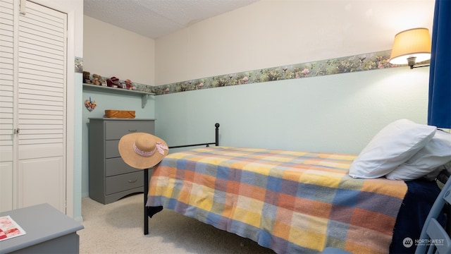 bedroom featuring light carpet and a textured ceiling