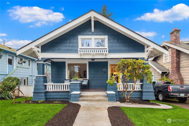 view of front of house featuring a porch and a front lawn