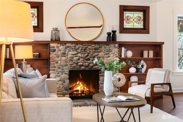 sitting room featuring a wealth of natural light, hardwood / wood-style floors, and a fireplace