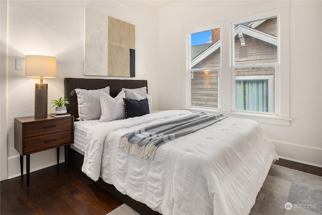 bedroom with dark wood-type flooring