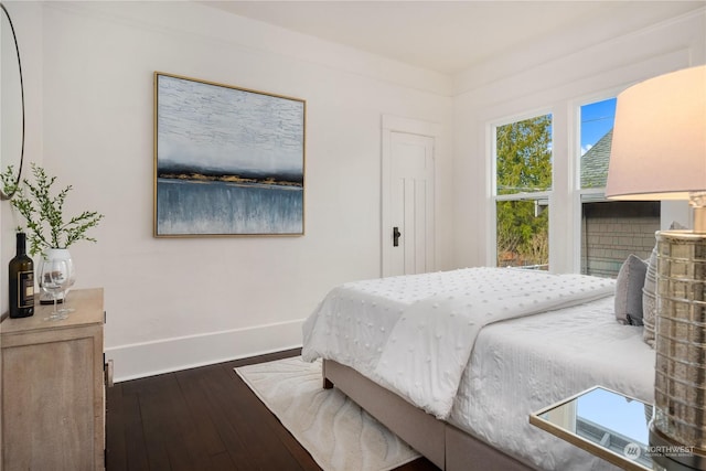 bedroom with dark wood-type flooring