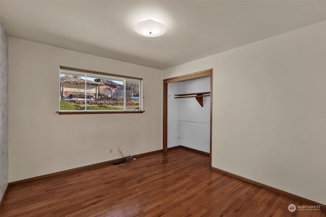 unfurnished bedroom with hardwood / wood-style flooring and a closet