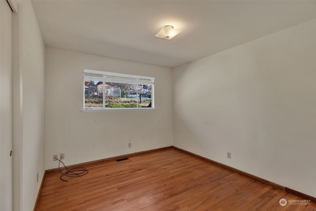 unfurnished room with light hardwood / wood-style floors